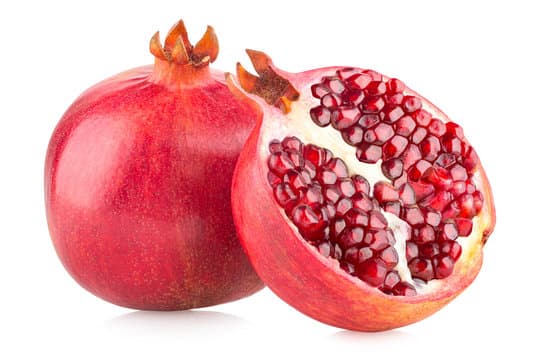 Fresh organic pomogranate displayed on a natural surface, clean and ready to use.